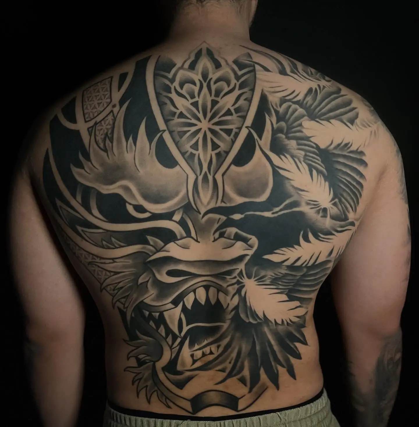 Full back blackwork piece with a mandala and dragon