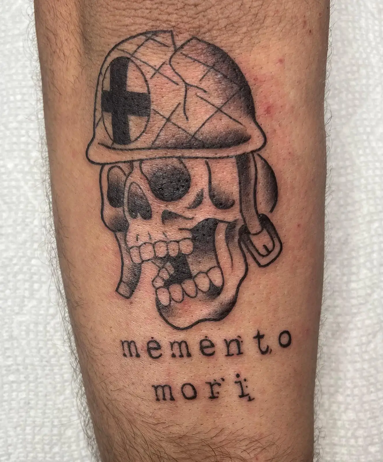 Skull in a medic helmet with memento mori script