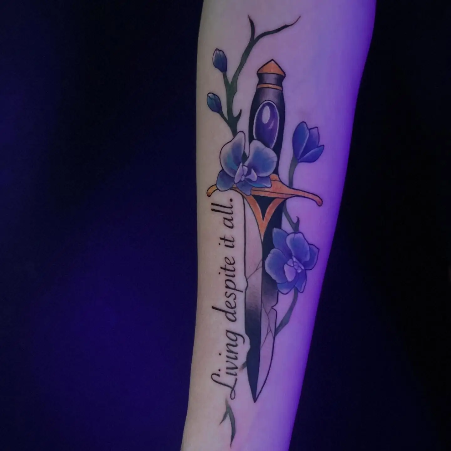 Dagger with purple orchids and a script quote