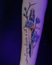 Dagger with purple orchids and a script quote