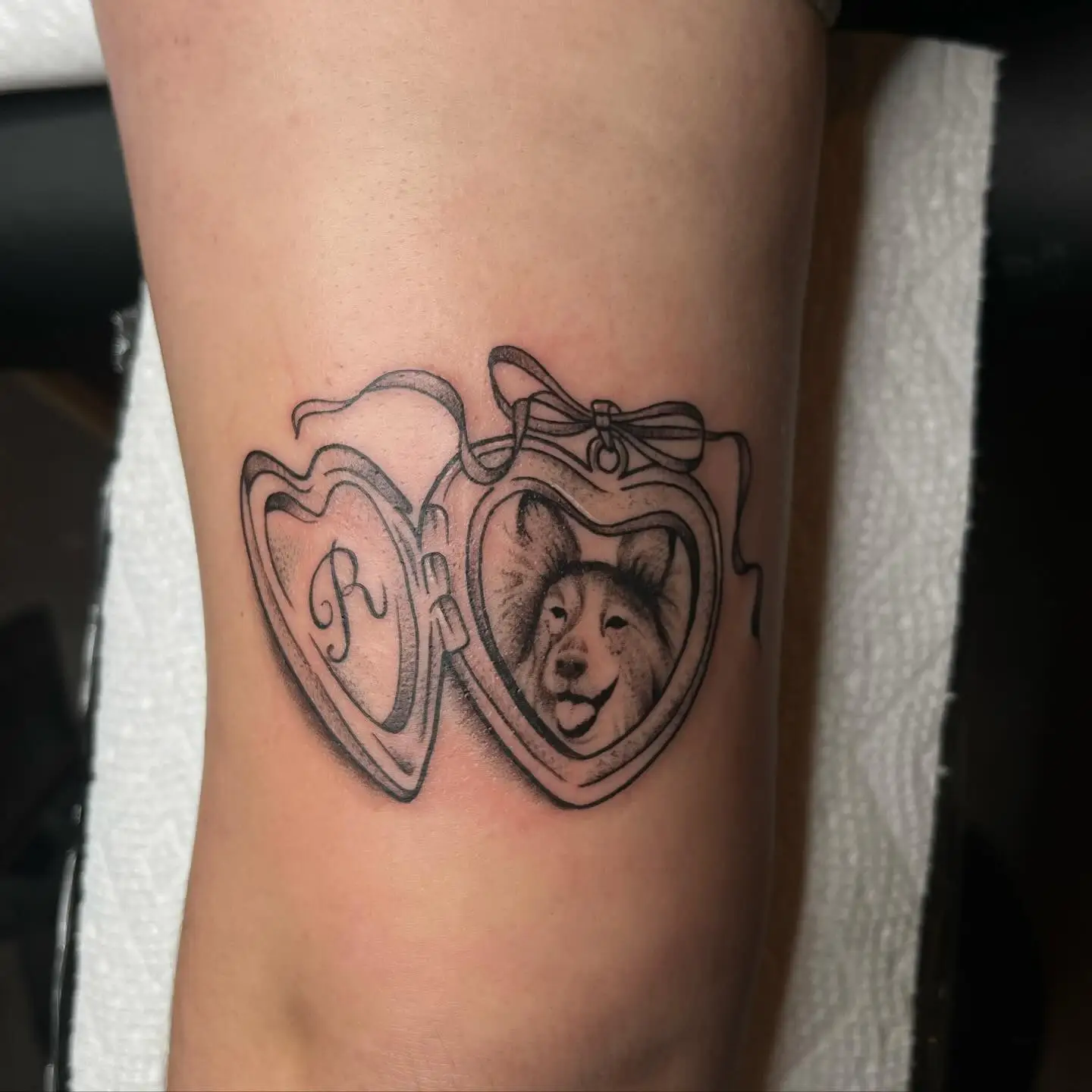 Two heart lockets, one with a dog portrait
