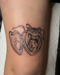 Two heart lockets, one with a dog portrait