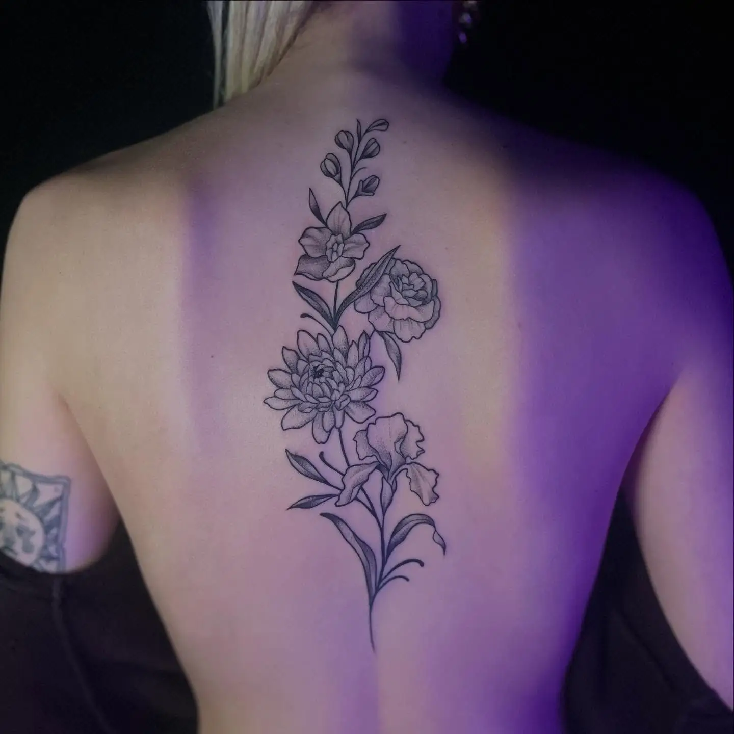 Long floral spine tattoo of family birth flowers