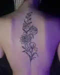 Long floral spine tattoo of family birth flowers
