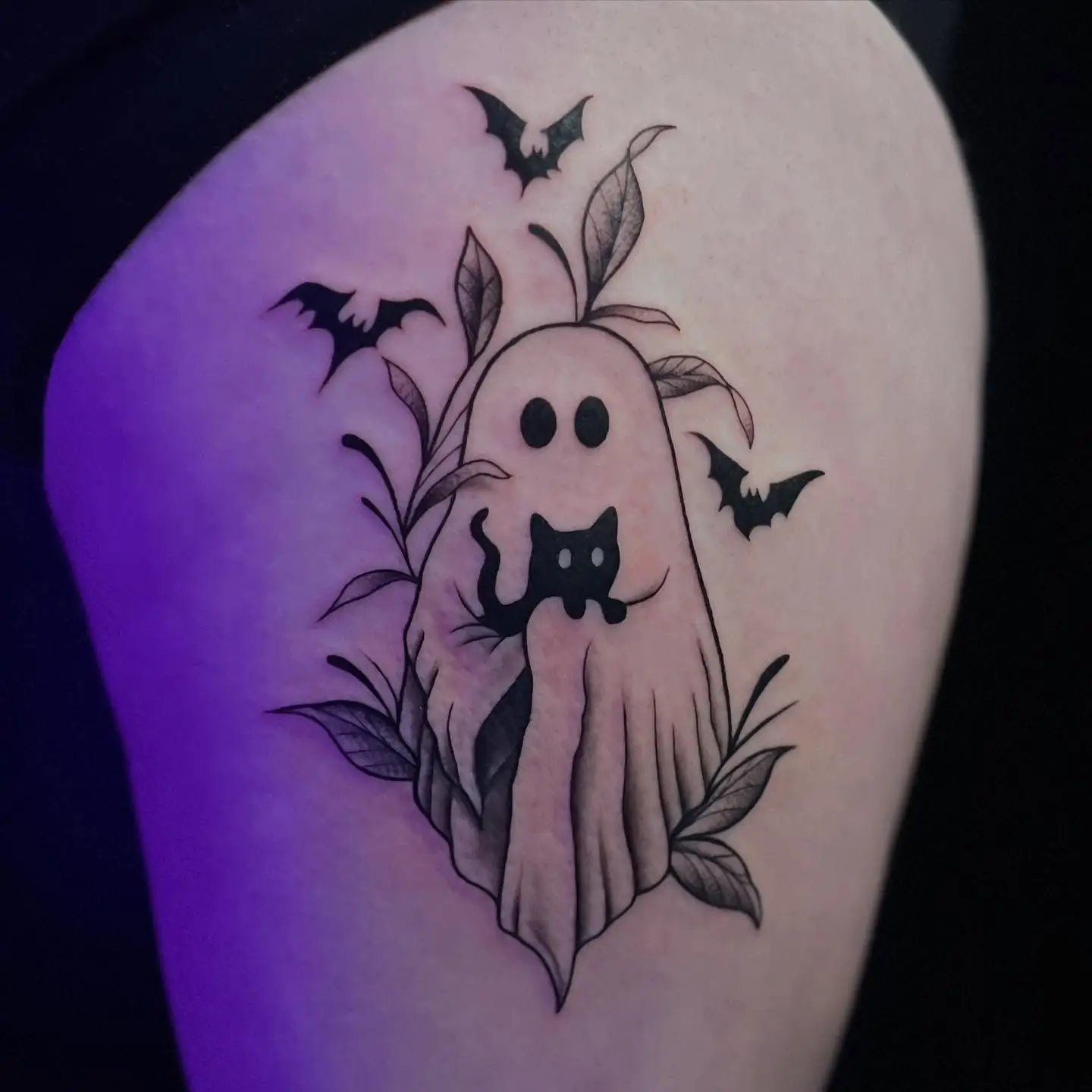 Sheet ghost holding a black cat with bats and leaves