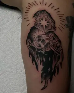 Traditional grim reaper with a halo in black and grey