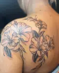 Black and grey hibiscus flowers wrapping a shoulder