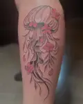 Jellyfish tattoo with pink cherry blossoms in its tentacles