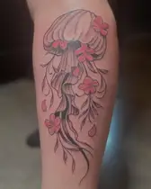 Jellyfish tattoo with pink cherry blossoms in its tentacles