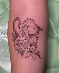 Fine line lamb with a sunflower and lily on a forearm