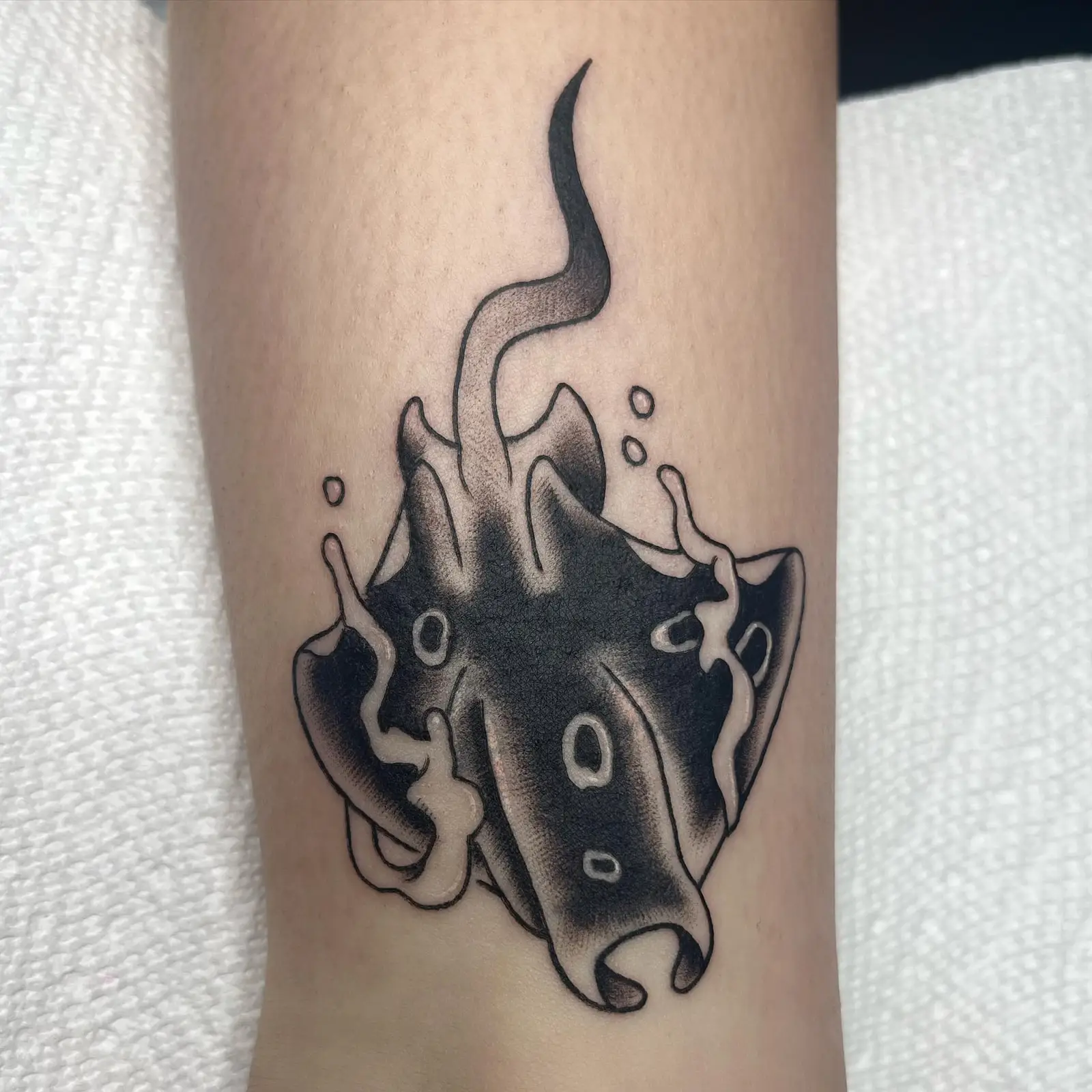 Black manta ray used to cover an older tattoo