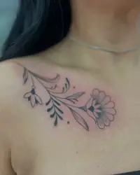 Delicate flower vine across a collarbone
