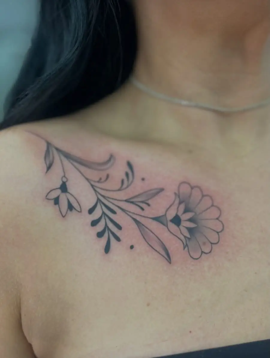 Delicate flower vine across a collarbone
