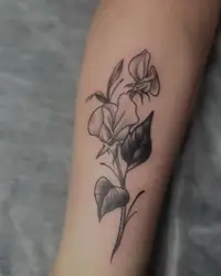 Sweet pea flower used as a cover-up on a forearm