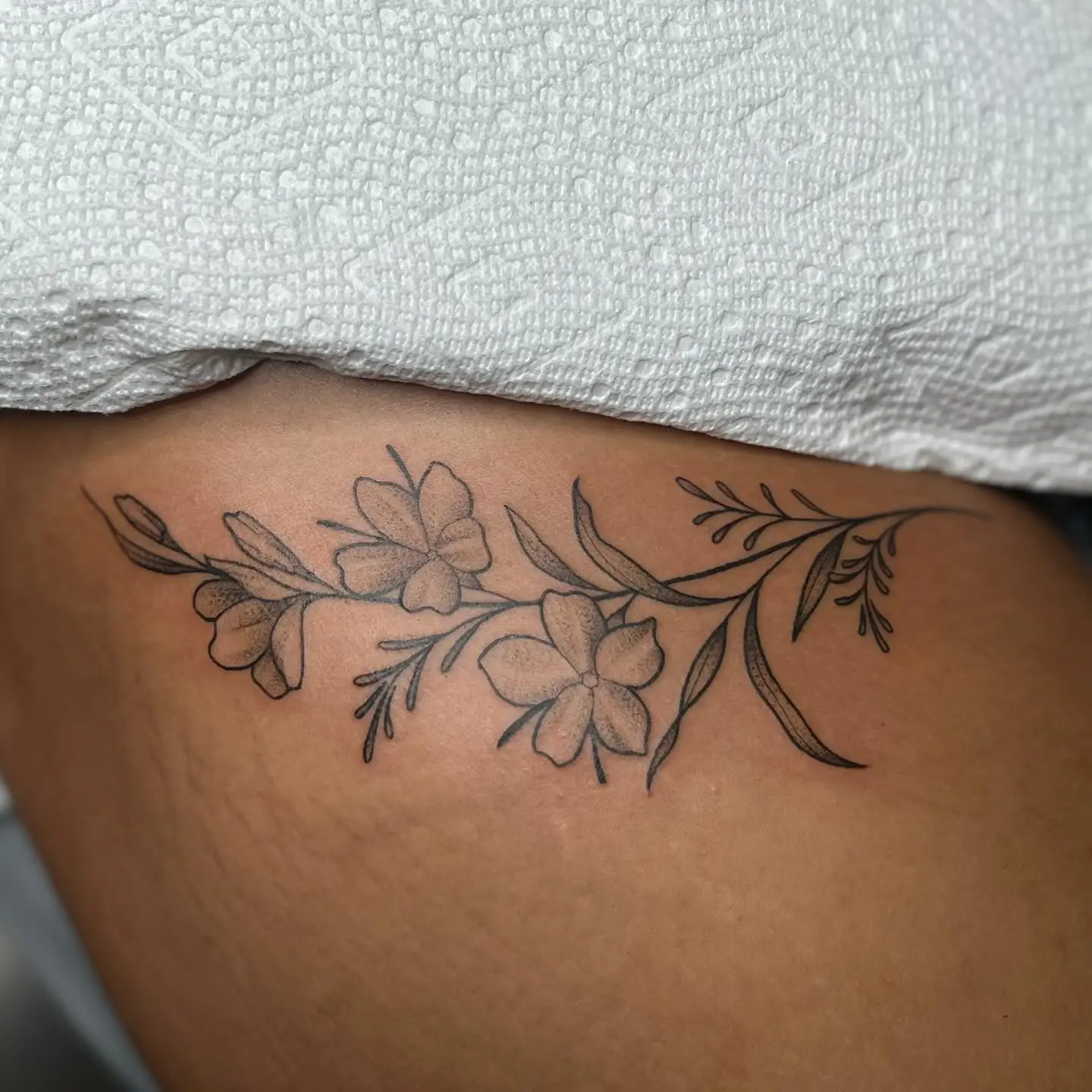 Floral vine across an upper thigh