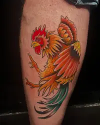 American traditional rooster tattoo in red, orange and green on a calf