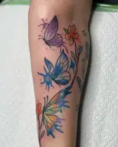 Butterflies and flowers with watercolor shading on a forearm